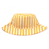 The Brighton baby cotton hat features yellow and white stripes—vertical on the crown, diagonal on the brim—for 360° sun protection. Made from breathable cotton for comfort, it’s shown against a white background.